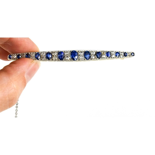 1 - An impressive diamond and cornflower blue sapphire brooch, of marquise form set with thirteen gradua... 