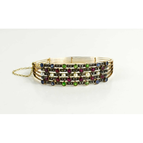 10 - A 19th century gold (tested as 14ct), diamond, pearl and coloured stone set bangle, set in five line... 