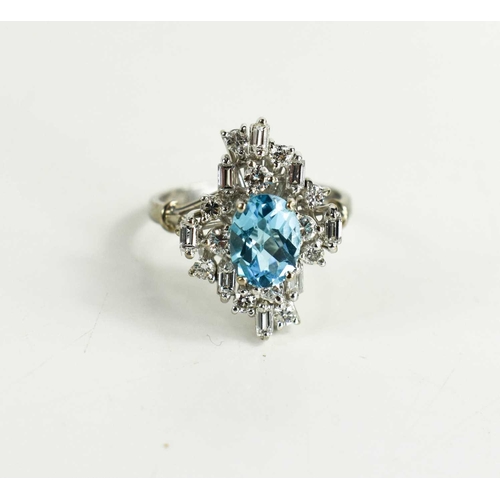 11 - An 18ct white gold, diamond and topaz dress ring, the central oval cut Topaz of approximately 6 by 8... 