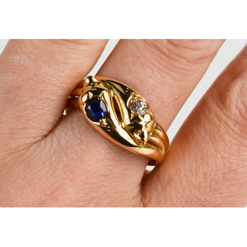 12 - An 18ct gold, sapphire and diamond snake ring, the two snake heads set with an old cut diamond and a... 