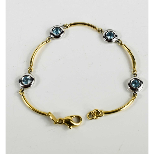 128 - An 18ct gold and white gold Italian bracelet set with four aquamarines, 8.1g, 19cm long.