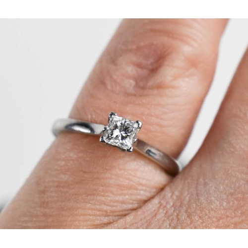 140 - A Phillip Stoner 950 Platinum and diamond solitaire ring, the princess cut stone of approximately 0.... 