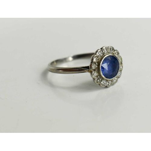 141 - An Art Deco sapphire and diamond flowerhead ring, with central deep cornflower blue sapphire surroun... 