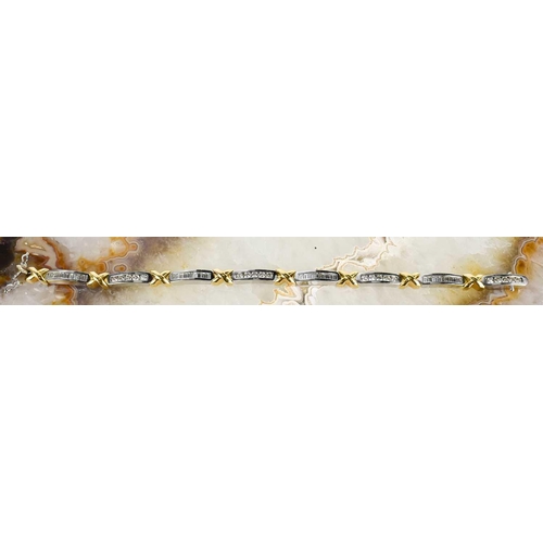 15 - An 18ct white & yellow gold and diamond bracelet, designed as series of eight diamond set white link... 