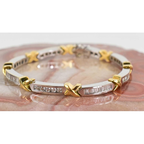 15 - An 18ct white & yellow gold and diamond bracelet, designed as series of eight diamond set white link... 