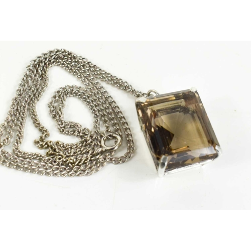 154 - A silver and smokey quartz ring, together with a similar pendant and chain and two silver rope twist... 