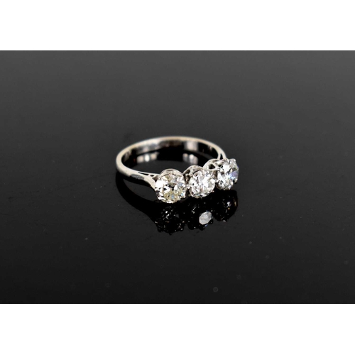 16 - A platinum and three stone diamond ring, the brilliant cut diamonds each approximately 0.65cts, in c... 