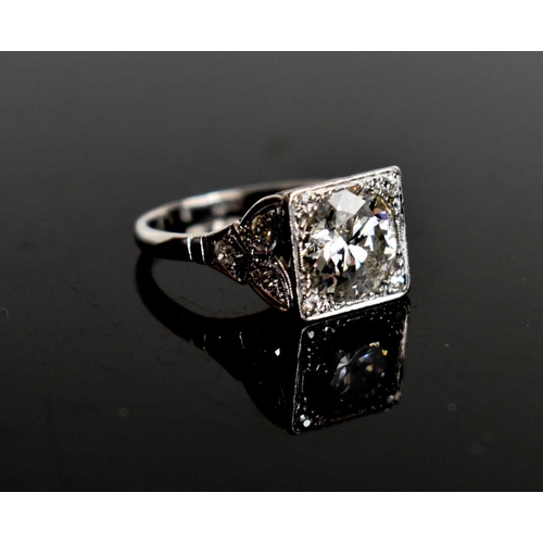 17 - An Art Deco style diamond and platinum dress ring, the central brilliant cut stone of approximately ... 