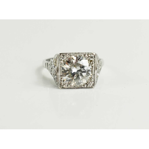 17 - An Art Deco style diamond and platinum dress ring, the central brilliant cut stone of approximately ... 