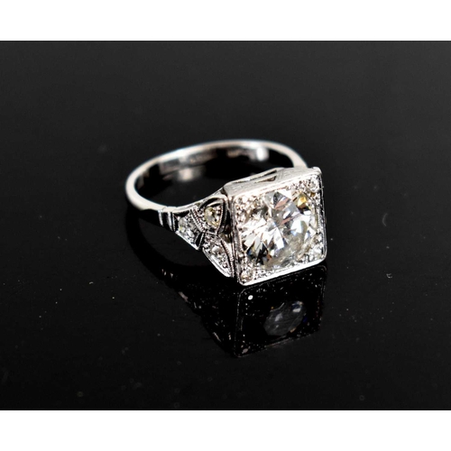 17 - An Art Deco style diamond and platinum dress ring, the central brilliant cut stone of approximately ... 