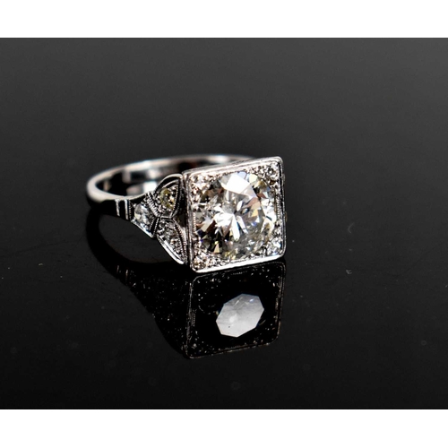 17 - An Art Deco style diamond and platinum dress ring, the central brilliant cut stone of approximately ... 