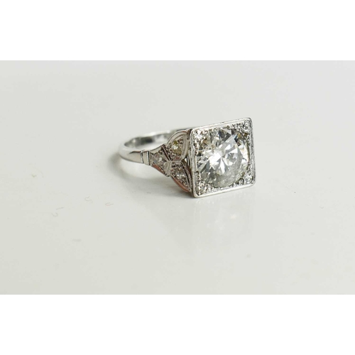 17 - An Art Deco style diamond and platinum dress ring, the central brilliant cut stone of approximately ... 