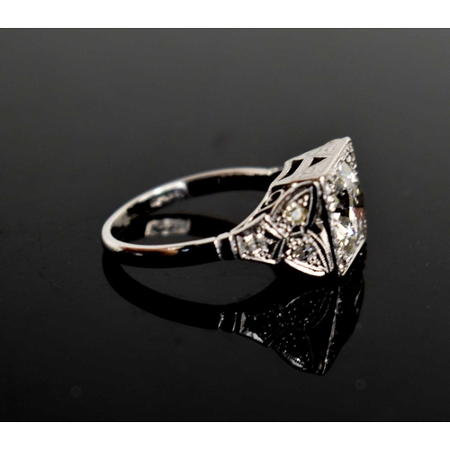 17 - An Art Deco style diamond and platinum dress ring, the central brilliant cut stone of approximately ... 