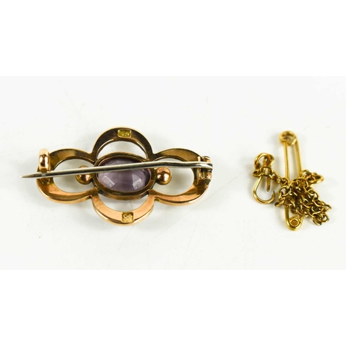 196 - A vintage 9ct gold, seed pearl and amethyst brooch of curved, open, quatrafoil form, the oval cut am... 