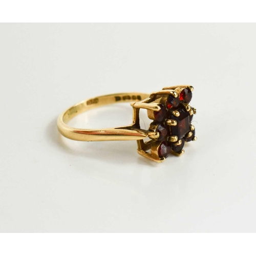 208 - A 9ct gold and garnet flowerhead ring, size O, 2.98g.