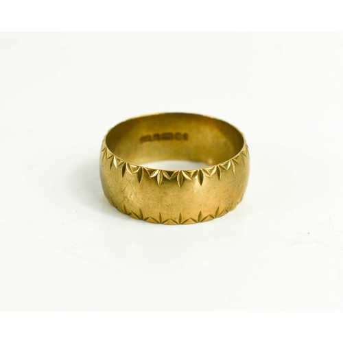 26 - A 9ct gold wedding band, with engraved decoration to the edges, size V, 5.86g.