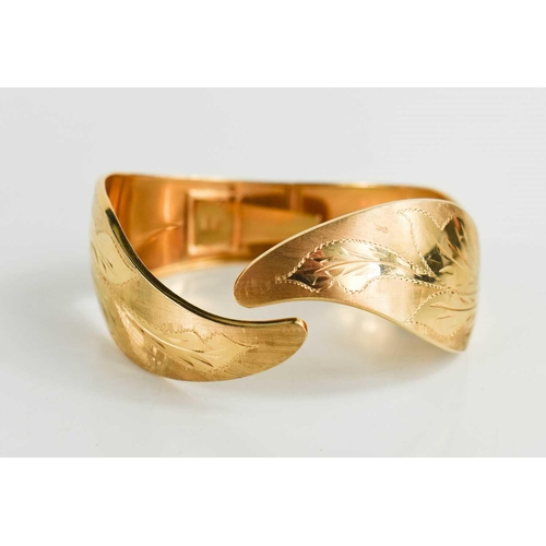 3 - An 18ct gold bangle, engraved with foliage and shaped in the form of leafy fronds, 30g.