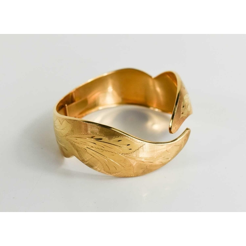 3 - An 18ct gold bangle, engraved with foliage and shaped in the form of leafy fronds, 30g.