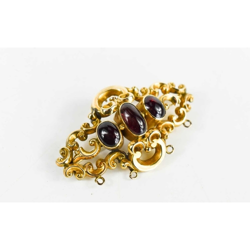 33 - A 19th century rolled gold and garnet three stone brooch.