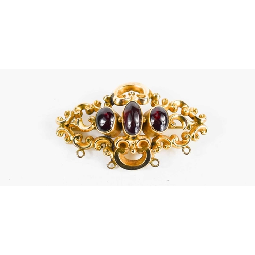 33 - A 19th century rolled gold and garnet three stone brooch.