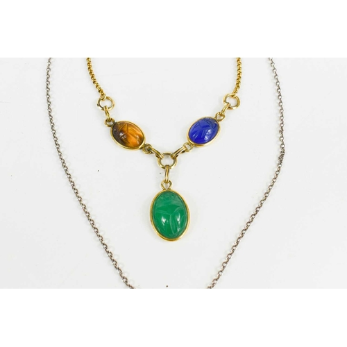 35 - Egyptian Revival interest, a three form scarab pendant of green, blue and tawny coloured stones, sus... 