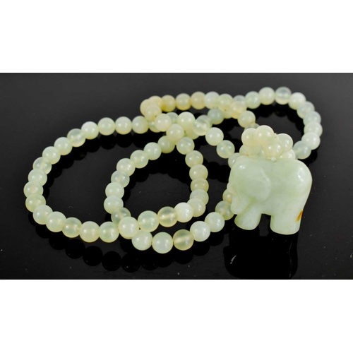 36 - A pale jade bead necklace, with elephant pendant, the necklace being approximately 76cm long, elepha... 