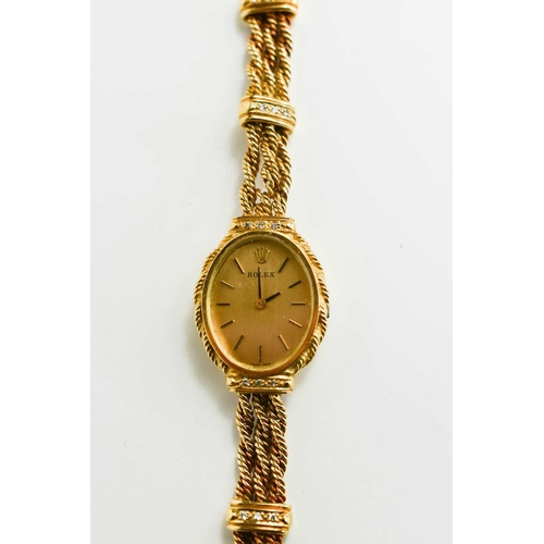 389 - An 18ct gold Rolex watch, with gold coloured oval dial, the triple ropetwist strap having diamond se... 