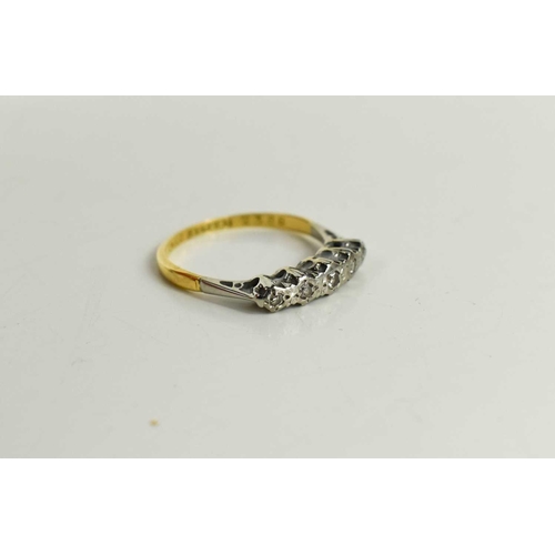 43 - An 18ct gold, platinum and diamond ring, the five brilliant cut graduated diamonds in an illusion se... 