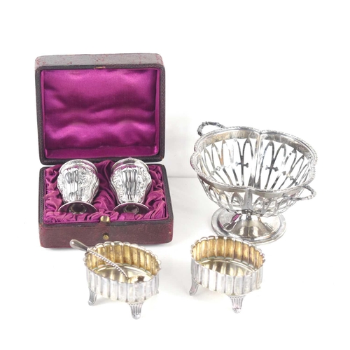 464 - A pair of Victorian silver pepperettes in the original case, together with two silver salts and spoo... 