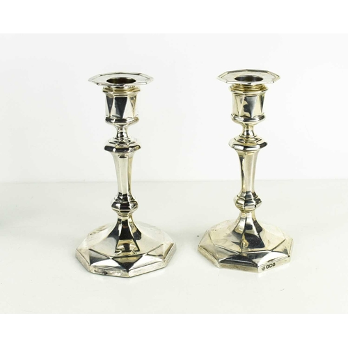 465 - A pair of silver candlesticks, with shaped columns, Sheffield 1921, 15cm high.