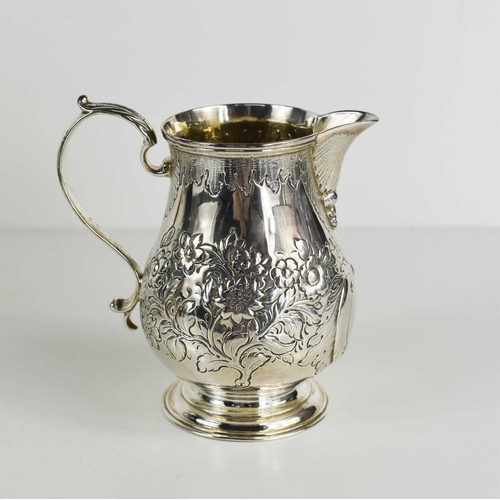 468 - A Georgian silver jug, embossed with flowers and foliage, London 1830, 7.39toz.