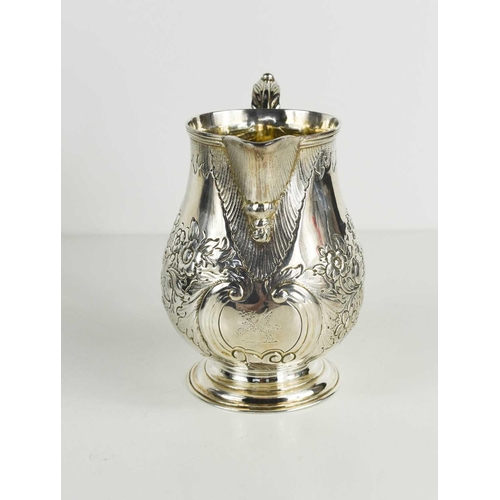 468 - A Georgian silver jug, embossed with flowers and foliage, London 1830, 7.39toz.