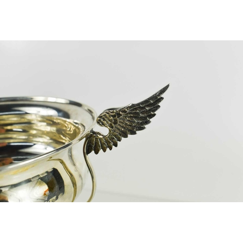 472 - A silver twin handled winged trophy, in the Art Deco style, Sheffield 1908, the wings engraved with ... 