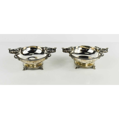 473 - A pair of silver bon-bon dishes of circular pedestal form with snakes and lions handles and lion fee... 