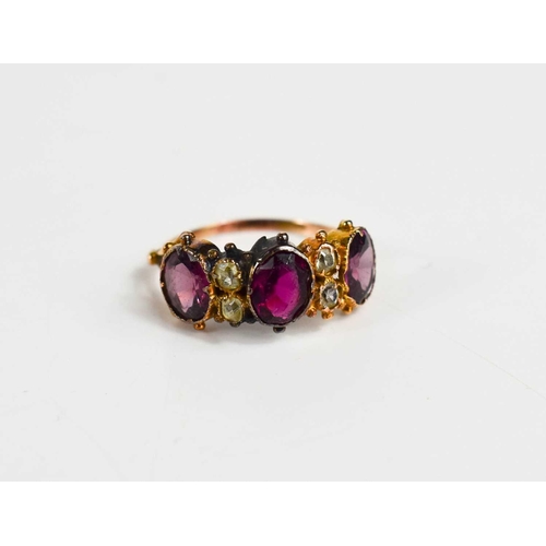 48 - A 19th century gold (unmarked) and paste ring, the three oval cut pink stones of differing shades, i... 