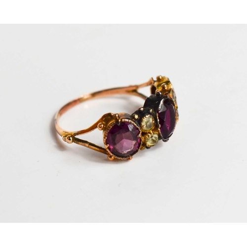 48 - A 19th century gold (unmarked) and paste ring, the three oval cut pink stones of differing shades, i... 