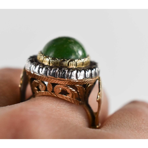 8 - A 19th century dress ring, set with oval green stone cabochon, 14.5 by 12mm, surrounded by twenty ei... 