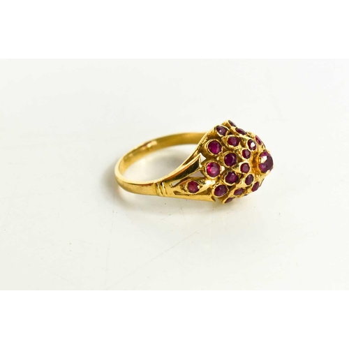 85 - A 14ct gold and pink sapphire cluster / flower head ring, of raised form with central brilliant cut ... 