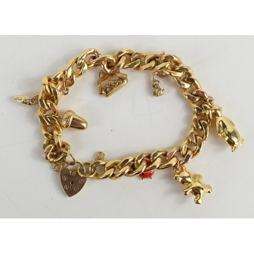 41a - A 9ct gold curb link charm bracelet with heart shaped padlock clasp and safety chain, with four 9ct ... 