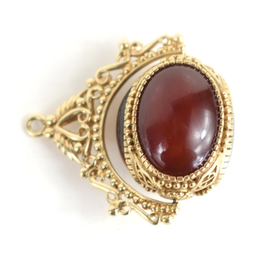 46a - A 9ct gold swivel fob, set with three large cabochons, of tiger's eye, black onyx and agate, within ... 