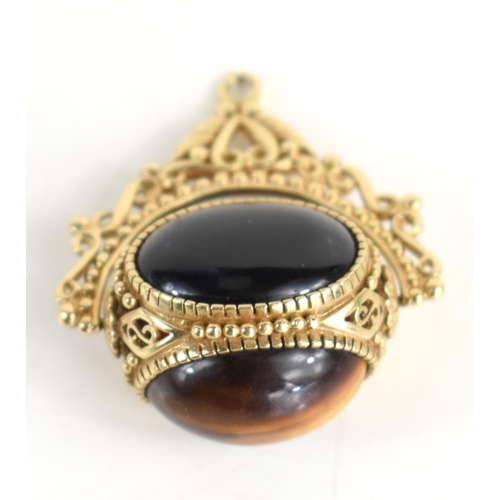 46a - A 9ct gold swivel fob, set with three large cabochons, of tiger's eye, black onyx and agate, within ... 