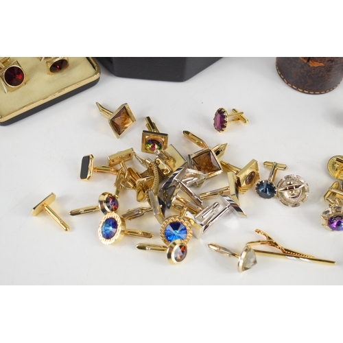 54a - A collection of twenty one pairs of gentleman's cufflinks, including a number of bright paste set ex... 