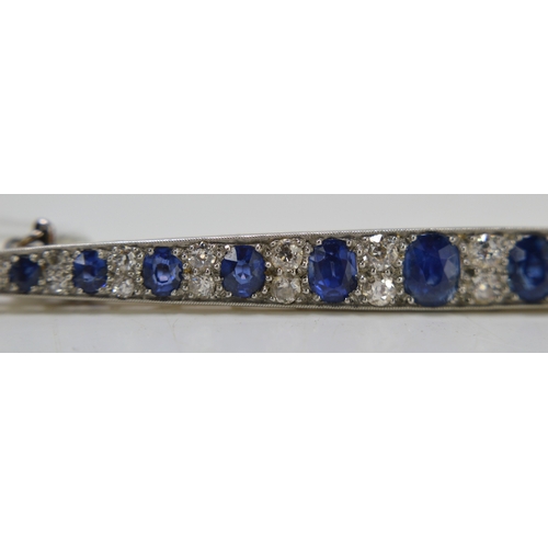 1 - An impressive diamond and cornflower blue sapphire brooch, of marquise form set with thirteen gradua... 