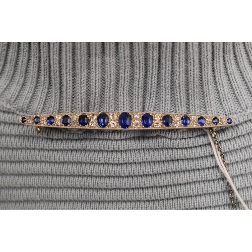 1 - An impressive diamond and cornflower blue sapphire brooch, of marquise form set with thirteen gradua... 