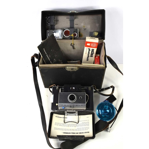 258 - A vintage Polaroid Automatic 100 Land Camera in its original fitted case with accessories to include... 