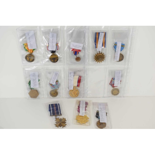 27 - A collection of USA military medals to include Berlin Airlift Humane Action medal, Legion of Merit, ... 