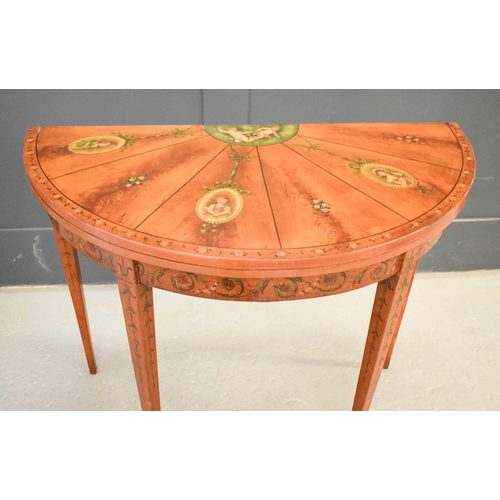 516 - A 19th century satinwood painted demi-lune card table, the top decorated with painted putti, ribbon ... 