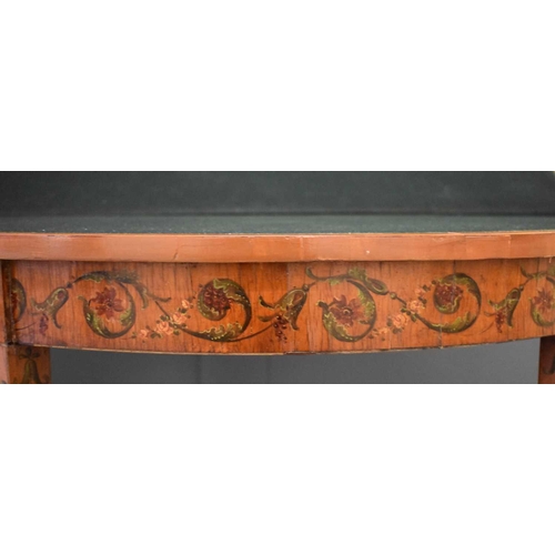 516 - A 19th century satinwood painted demi-lune card table, the top decorated with painted putti, ribbon ... 