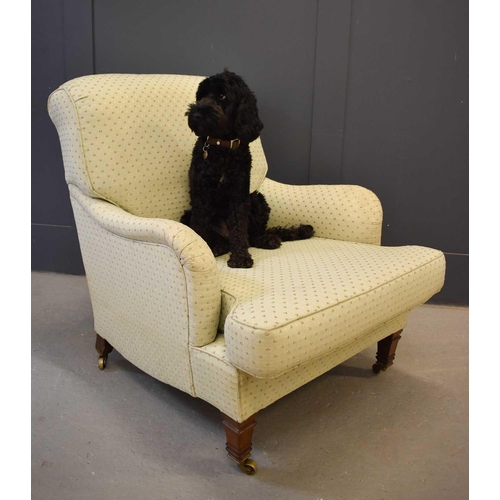 517 - A late 19th / early 20th century rosewood framed armchair, the castors stamped Howard & Sons, uphols... 