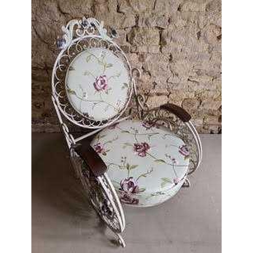 521 - A pair of fin-de-siecle cast iron garden chairs, with wrought iron roses, the frame painted cream wi... 